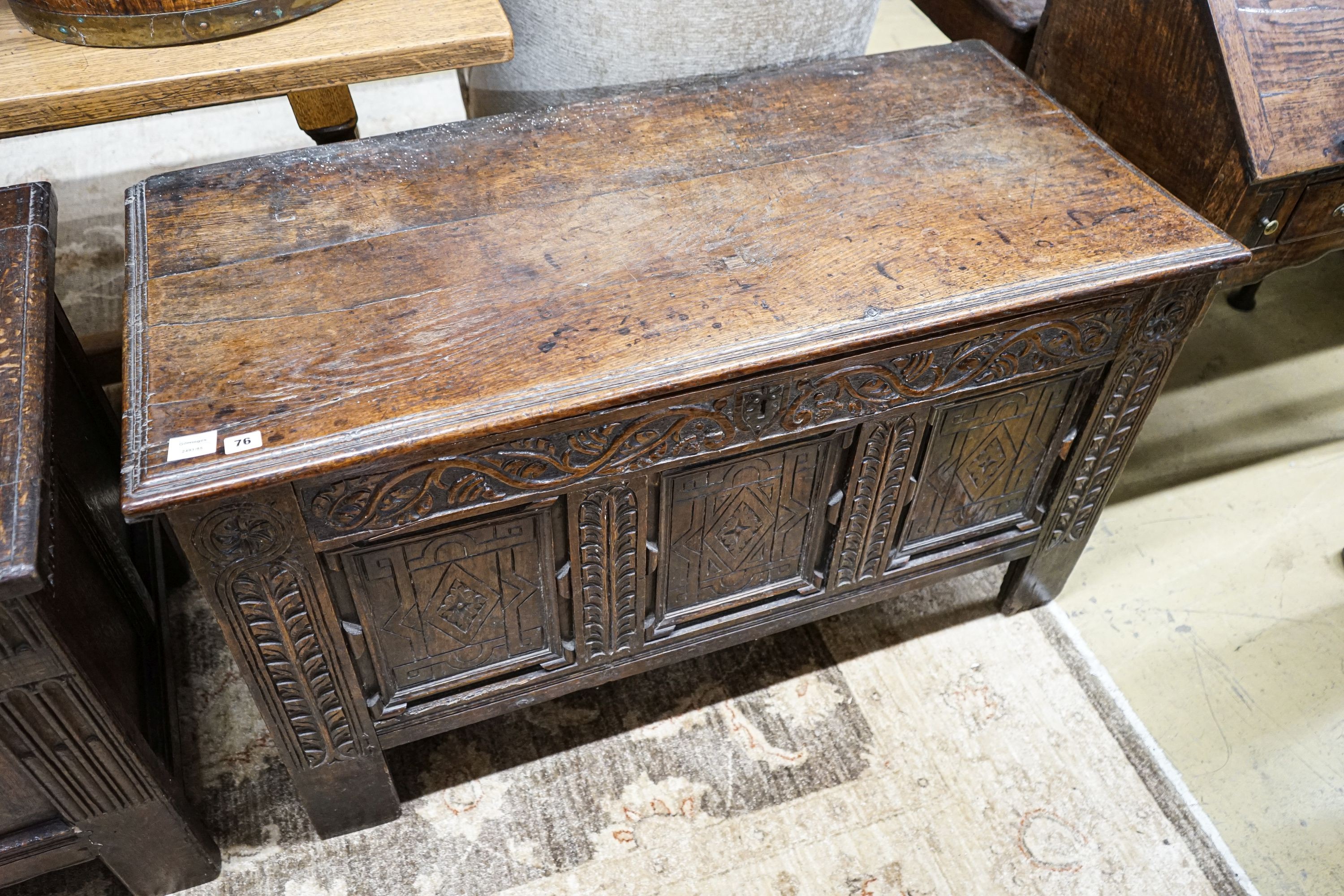 A 17th century oak coffer, with later carved front, length 120cm, depth 56cm, height 69cm